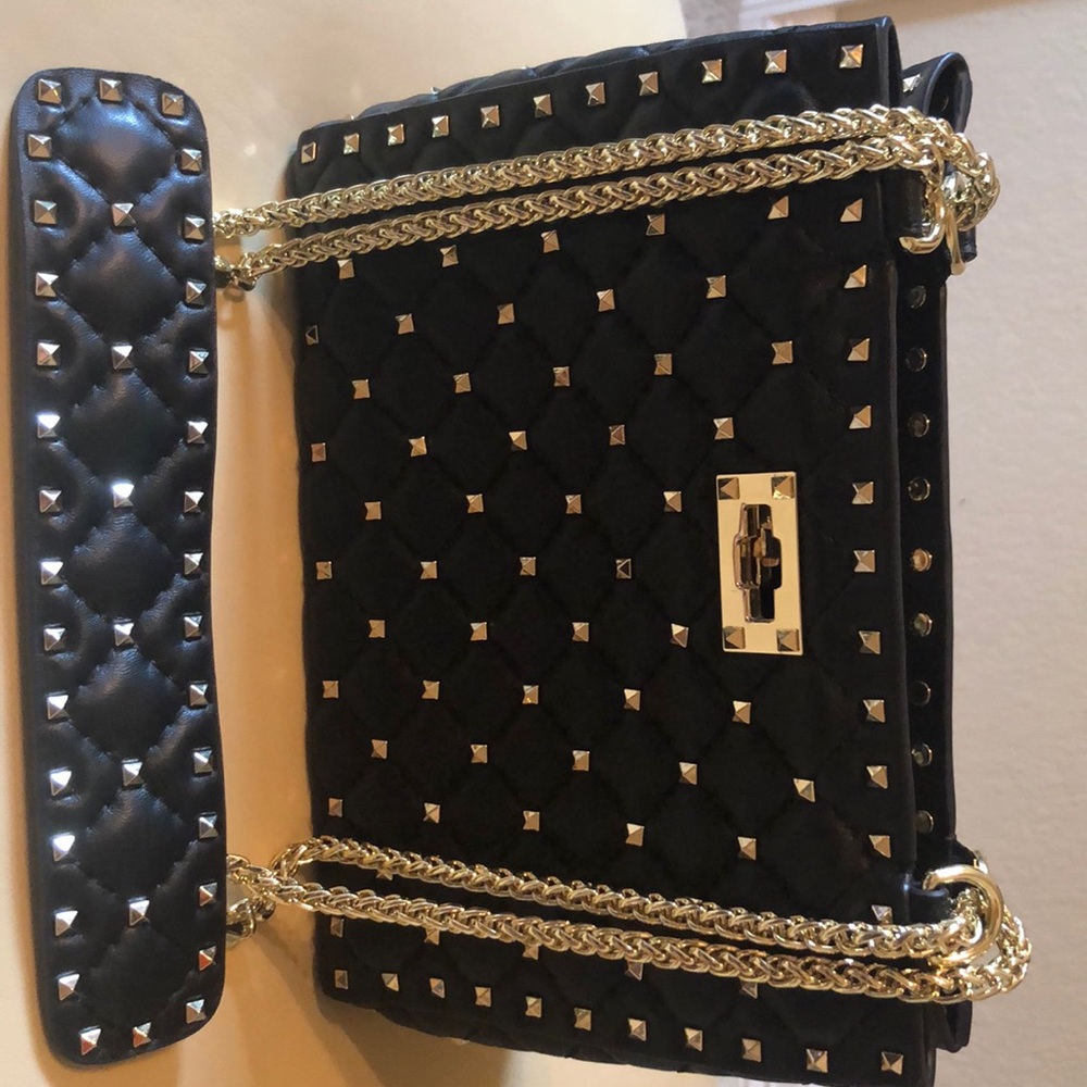 Black quilted handbag with chain strap.